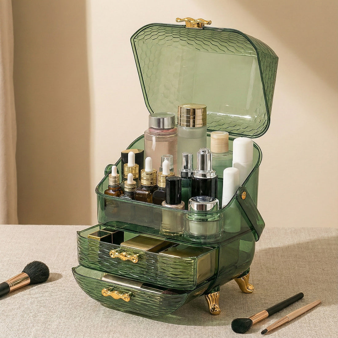 A green, vintage-style makeup organizer with multiple compartments and drawers, filled with skincare bottles, makeup products, and brushes displayed on a beige surface.