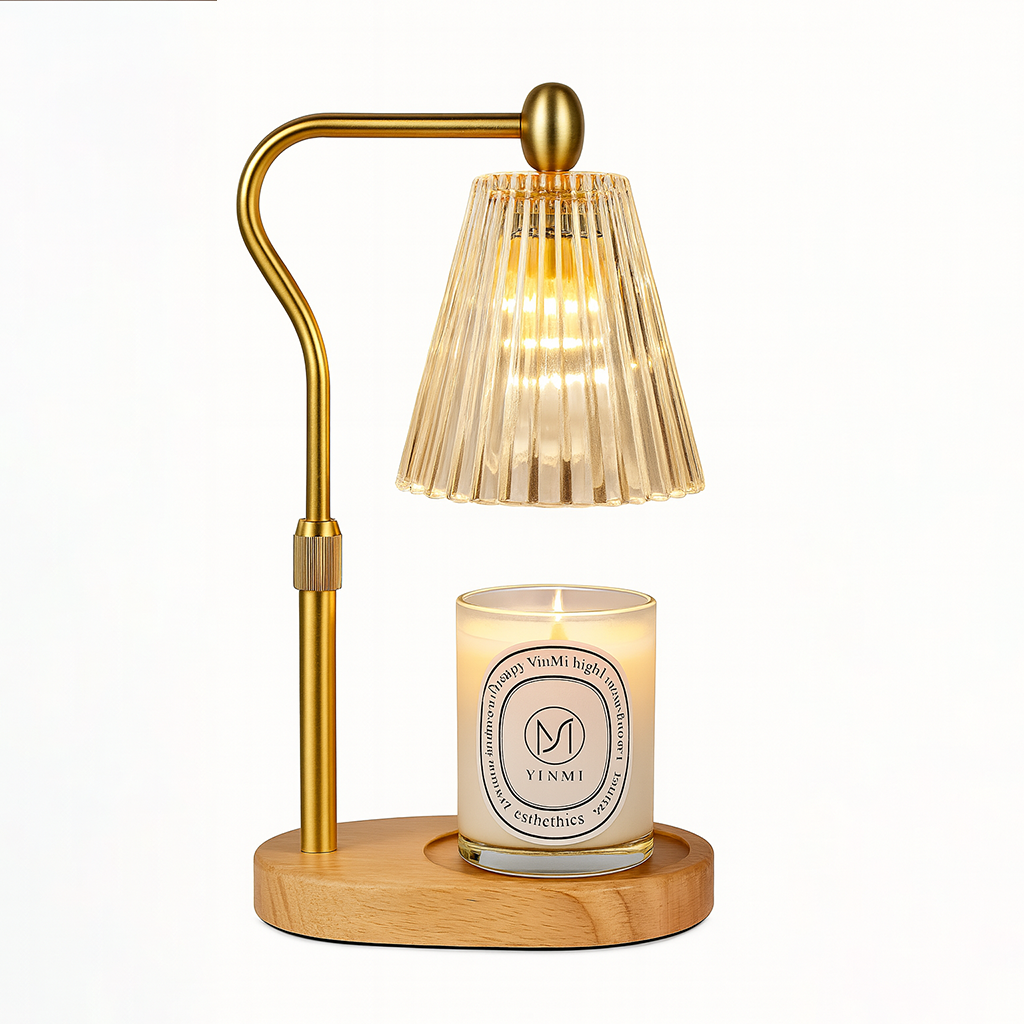 Gold candle warmer lamp with a ribbed glass shade and a lit scented candle on a wooden base, displayed on a white background.