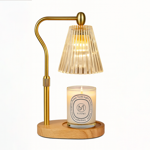 Gold candle warmer lamp with a ribbed glass shade and a lit scented candle on a wooden base, displayed on a white background.