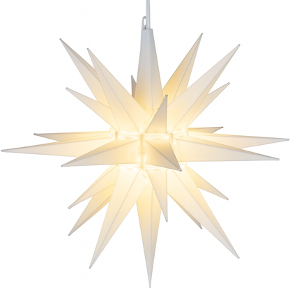 Moravian star hanging light emitting a warm glow, photographed on a white background.